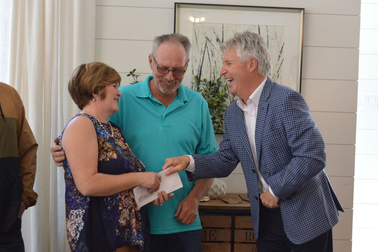 Bill Bean presents a cheque to the QEII Home Lottery winners 