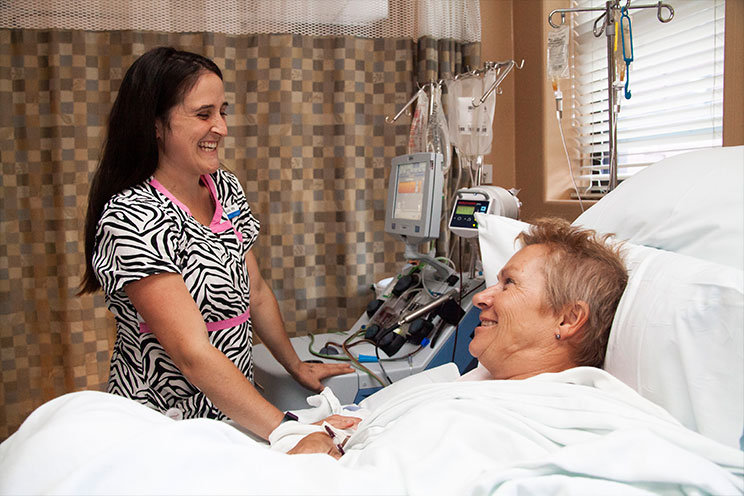 A nurse comforts a patient receiving cancer treatment at the QEII