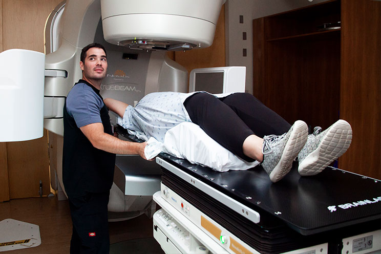 A patient getting radiation screening on a linear accelerator at the QEII