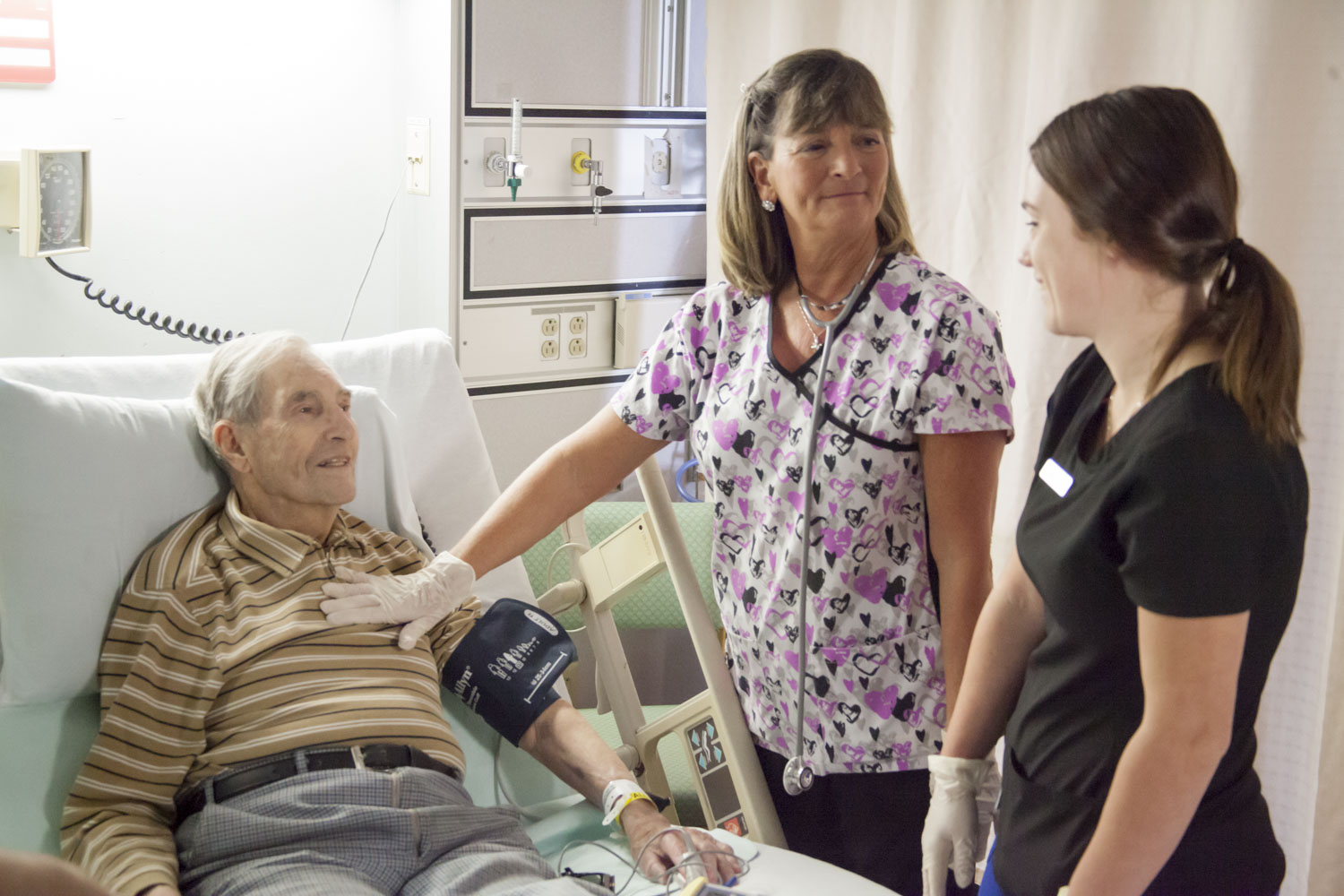 A patient having a conversation with two nurses