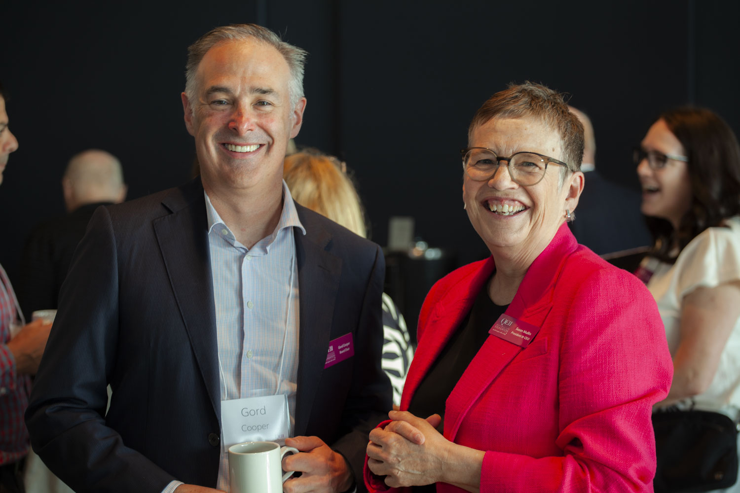 A man and woman smile at the camera. 