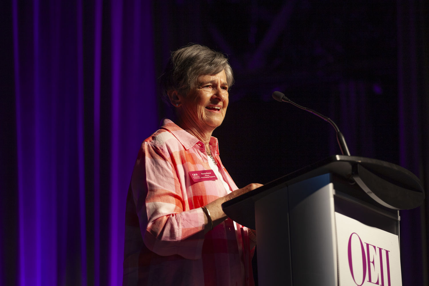 A woman speaks at a podium. 