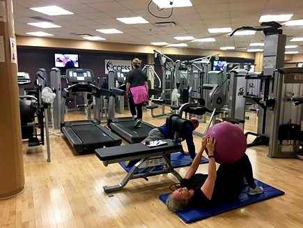 Group of people working out in small gym