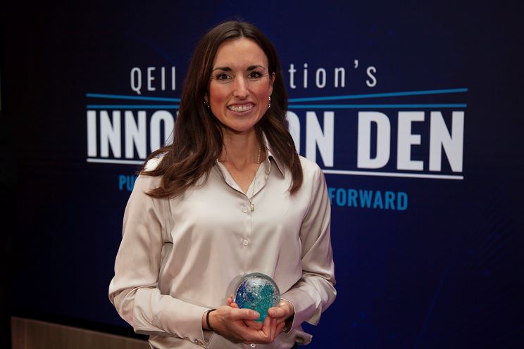 Dr. Jennifer Johnston holds an award as the inaugural recipient of the Innovation Catalyst Fund $100,000 prize. 