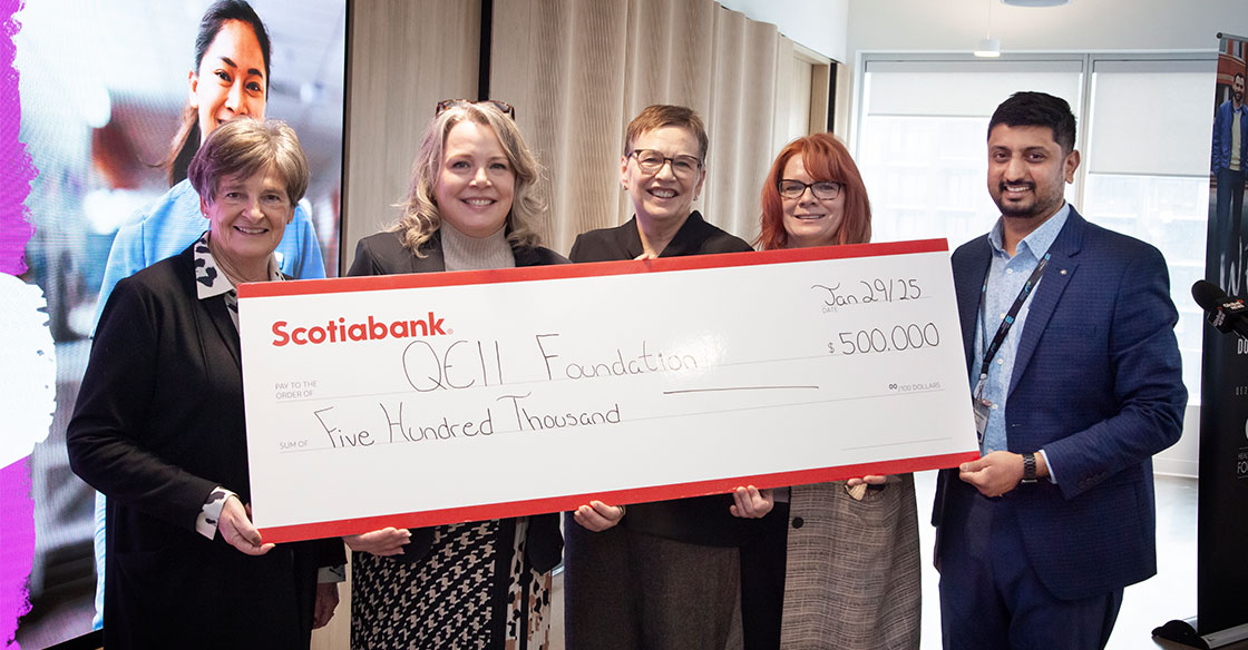 Individuals holding Scotiabank giant cheque