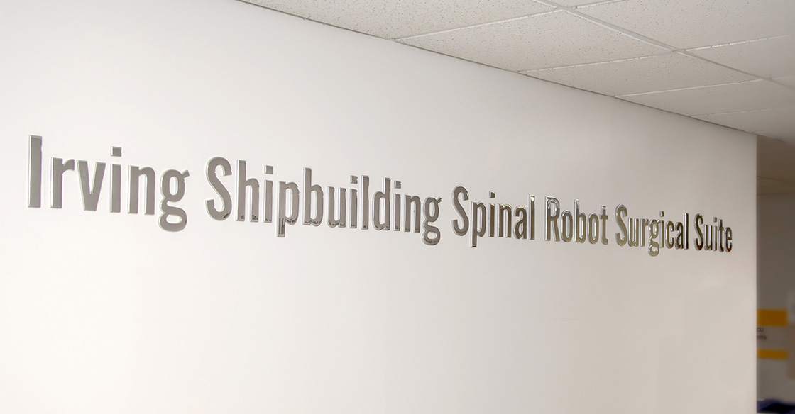 Wall sign reading 'Irving Shipbuilding Spina Robot Surgical Suite'
