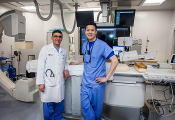 Dr. Hussein Beydoun (left) and Dr. Tony Lee (right) in Cardiac Cath Lab D.