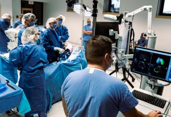 a healthcare team surrounds the orthopaedic surgical robot