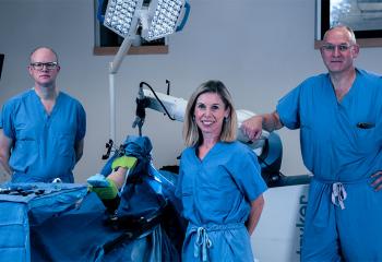 healthcare professionals stand with Canada's second orthopaedic robot
