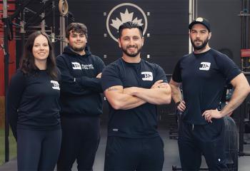 Four Blended Athletics employees dressed in black stand smiling 
