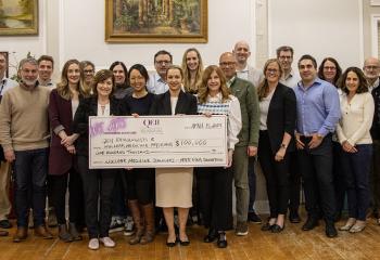 QEII physicians stand with photo of cheque 