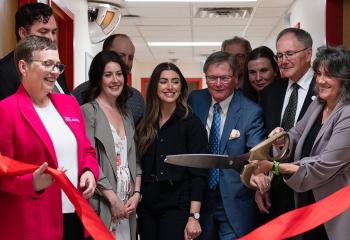 Group cutting ribbon to new clinic