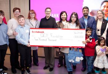 Families and staff holding cheque highlighting $500K donation