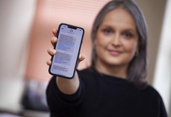 Woman holds phone