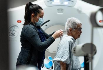 A patient is prepared for a scan at a new CT simulator.