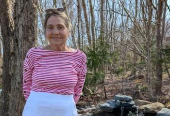 Pictured: Cheryl Bigood practices standing straight after receiving scoliosis surgery with the QEII's donor-funded surgical robot for spinal surgeries. 