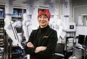 Dr Alison Wallace, pictured in the OR in front of the da Vinci Xi robot