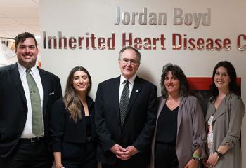 Boyd family stands in front of clinic naming