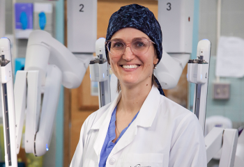 Dr. Lana Šačiragić stands with the da Vinci Xi surgical robot at the QEII. 