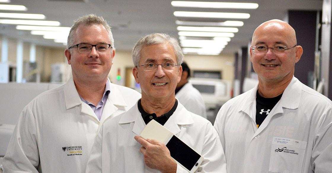 Dr. David Conrad, Dr. Alan Fine and Dr. Rob Liwski show off the hand-held prototype.