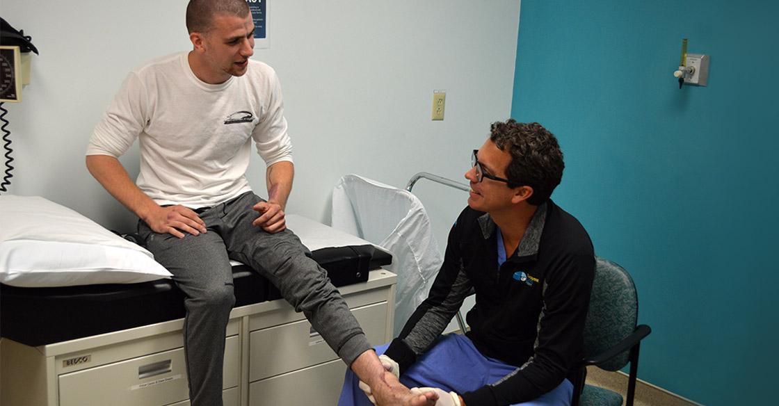 Plastic surgery patient Gregg McCulloch has his foot examined by Dr. Jason Williams.