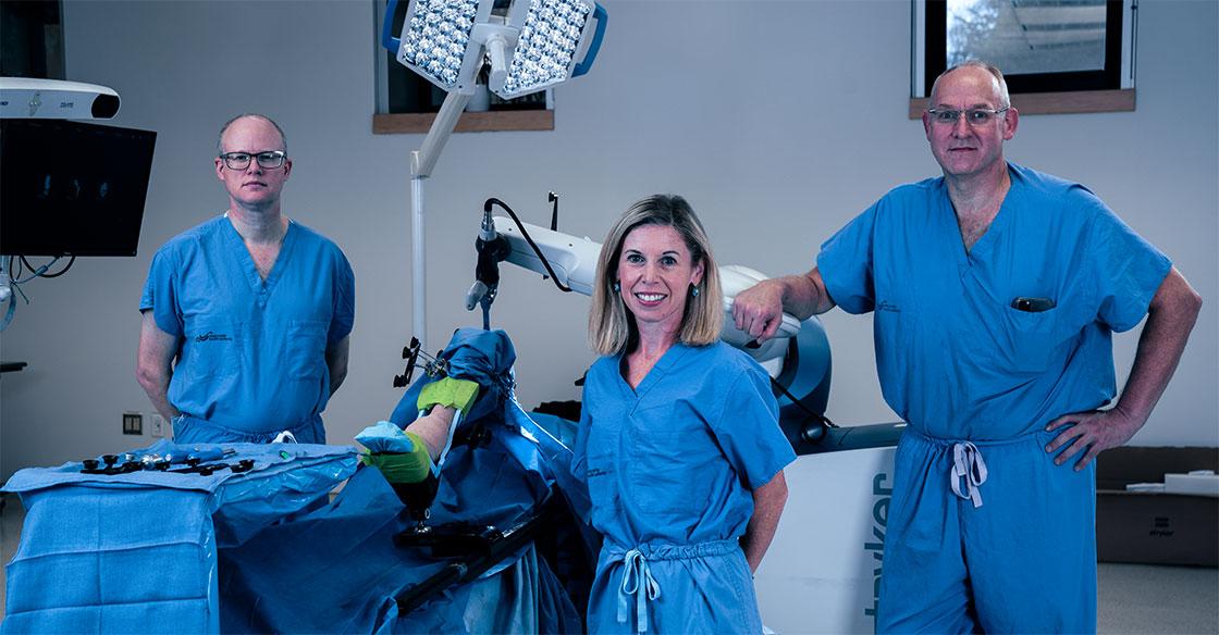 healthcare professionals stand with Canada's second orthopaedic robot