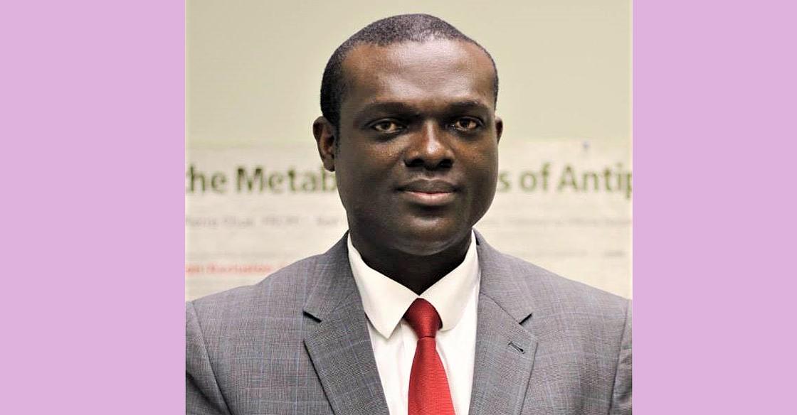 Dr. Vincent Agyapong wearing a gray suit and a red tie 