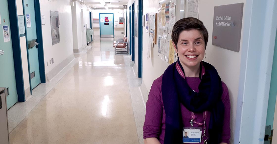 Rachel Millet stands smiling in a QEII hallway