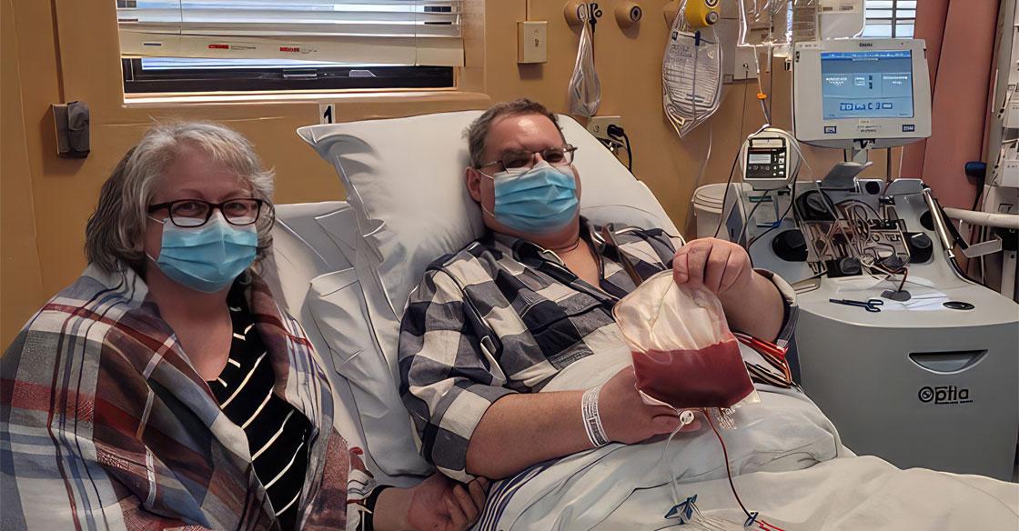 mmaline Jesso (left) pictured with her husband, Charles, during his lifesaving CAR-T therapy treatment.