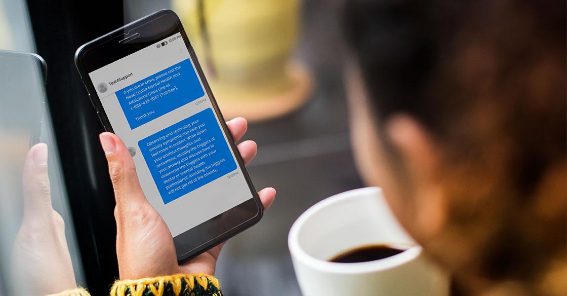 Woman holding cell phone, featuring Text4Support messages