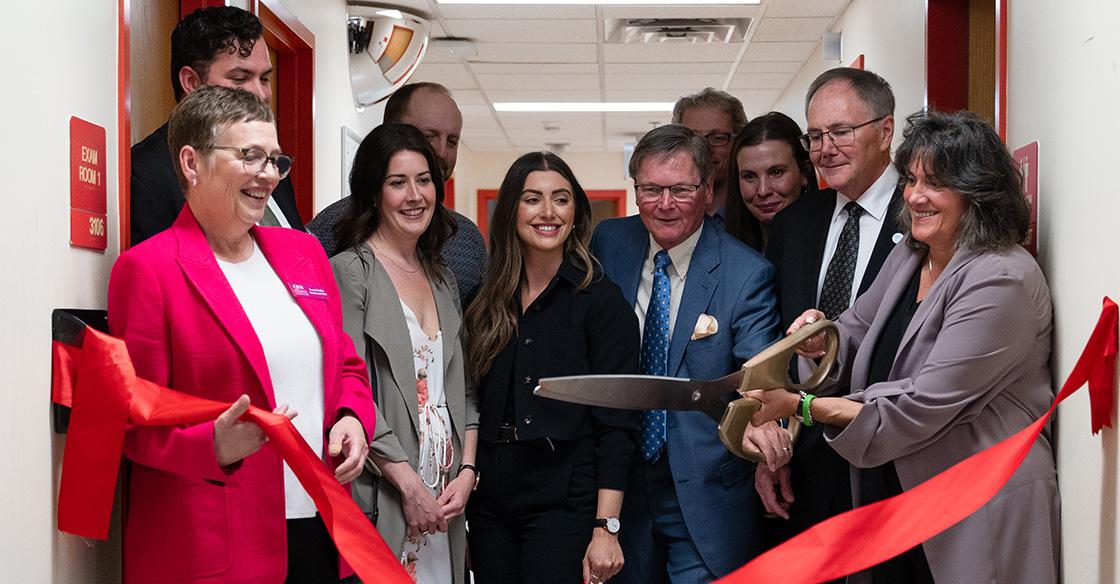 Group cutting ribbon to new clinic
