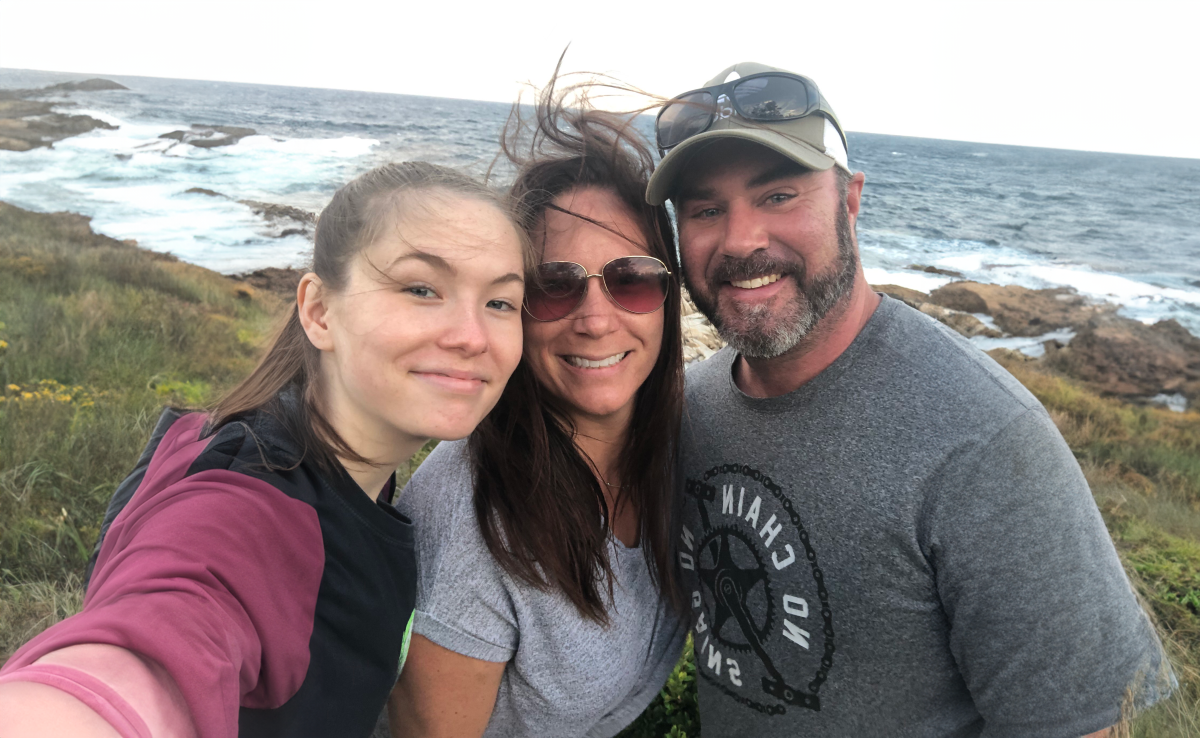 Photo of three people on a beach