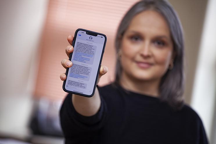 Woman holds phone