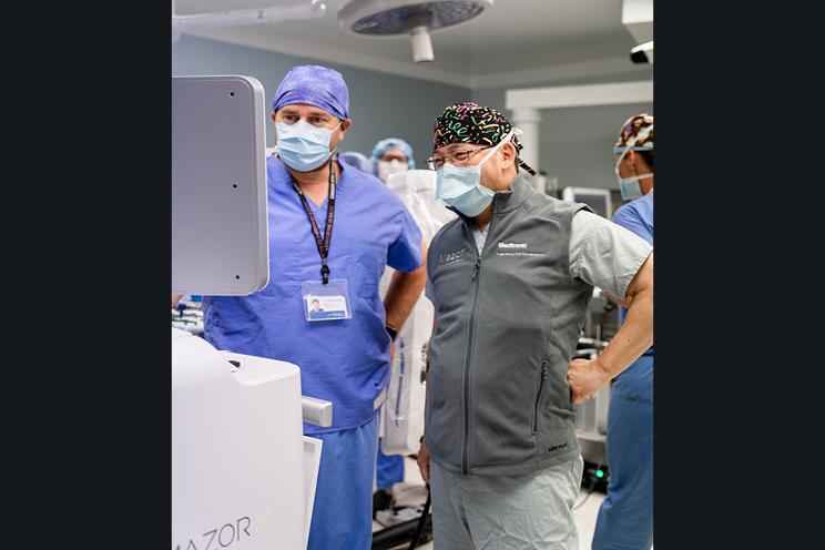 QEII surgeons work with the new spinal surgical robot.