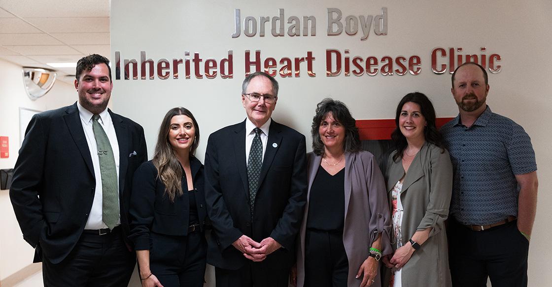 Family standing in front of clinic sign