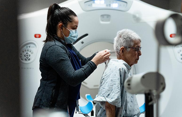 A patient is prepared for a scan at a new CT simulator.