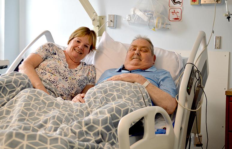 A patient and his wife share a moment in a cuddle bed in the QEII's palliative care unit.