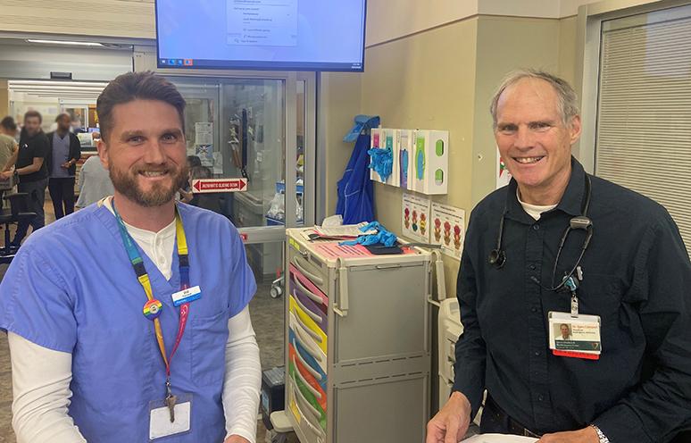 A QEII emergency department pharmacist and emergency medicine physician pose for the camera in the QEII's emergency department.