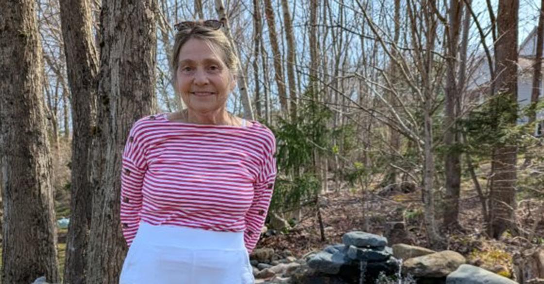 Pictured: Cheryl Bigood practices standing straight after receiving scoliosis surgery with the QEII's donor-funded surgical robot for spinal surgeries. 