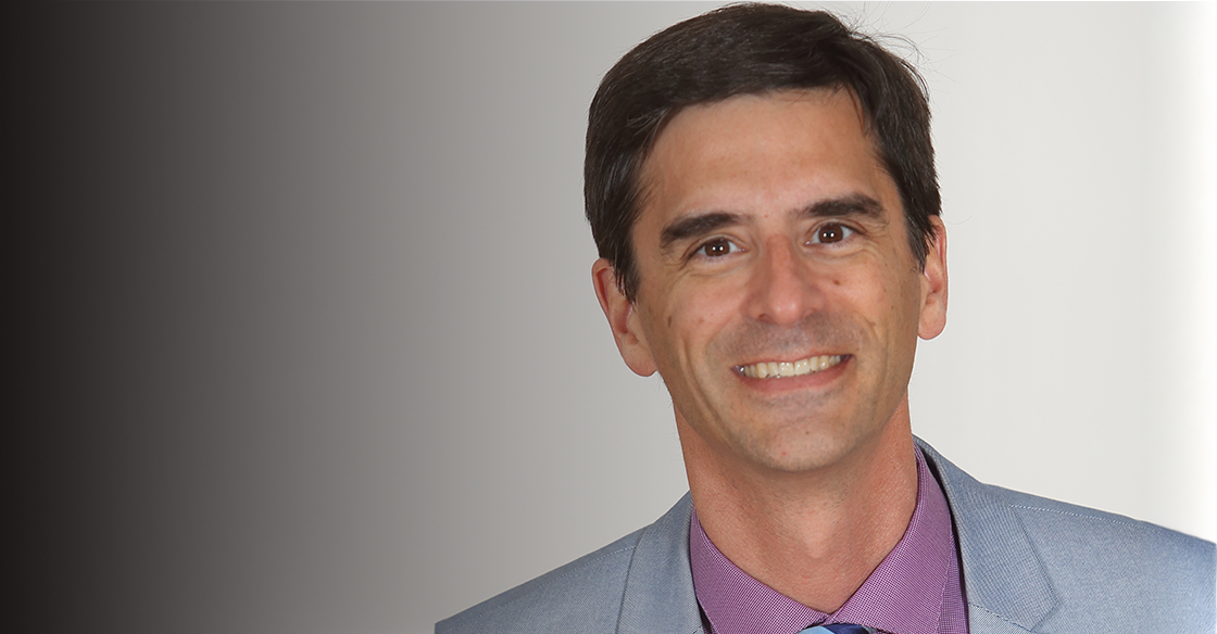 Dr. John Sapp smiling at the camera.