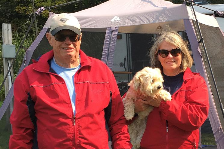 Peter and Michele Shaver hold their small dog while on an RV trip.