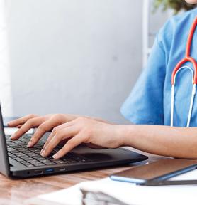 Healthcare professional working on laptop
