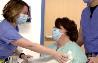 QEII staff covers patient with a blanket