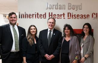 Boyd family stands in front of clinic naming