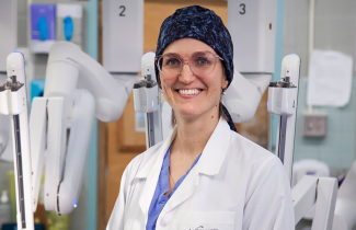 Dr. Lana Šačiragić stands with the da Vinci Xi surgical robot at the QEII. 