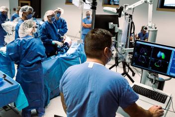 A group of QEII surgeons gather around the Mako SmartRobotic system