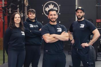 Four Blended Athletics employees dressed in black stand smiling 