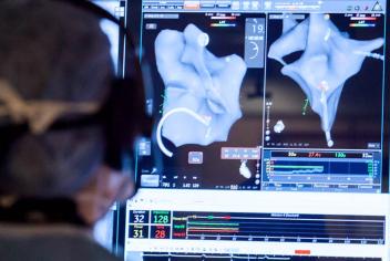 A surgeon is using the screen to operate in Atlantic Canada's first hybrid operating room