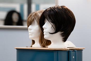 wigs displayed in sunshine room