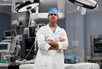 Dr Ribeiro standing in OR, with arms crossed and smiling